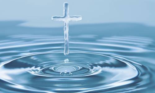 A picture of a splash in water with the splash looking like a cross