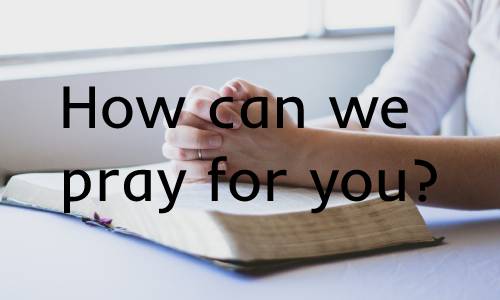 photo of someone praying over a Bible with the words "how can we pray for you?"